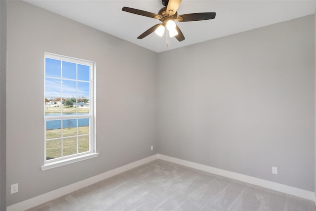 carpeted spare room with ceiling fan