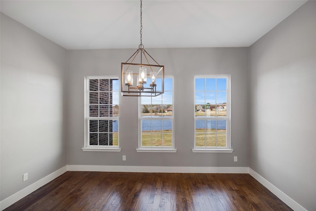 unfurnished room featuring ceiling fan, dark wood-type flooring, and plenty of natural light