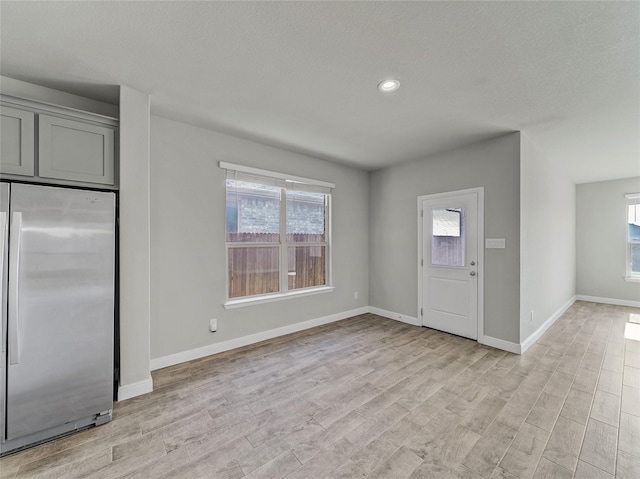 entrance foyer with plenty of natural light and light hardwood / wood-style floors