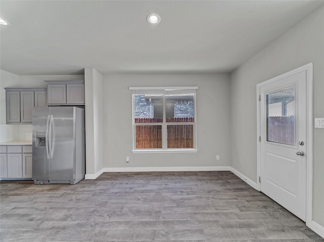 unfurnished dining area featuring light hardwood / wood-style floors