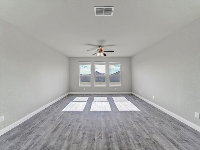 empty room with hardwood / wood-style flooring and ceiling fan