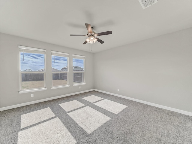 empty room featuring ceiling fan and carpet