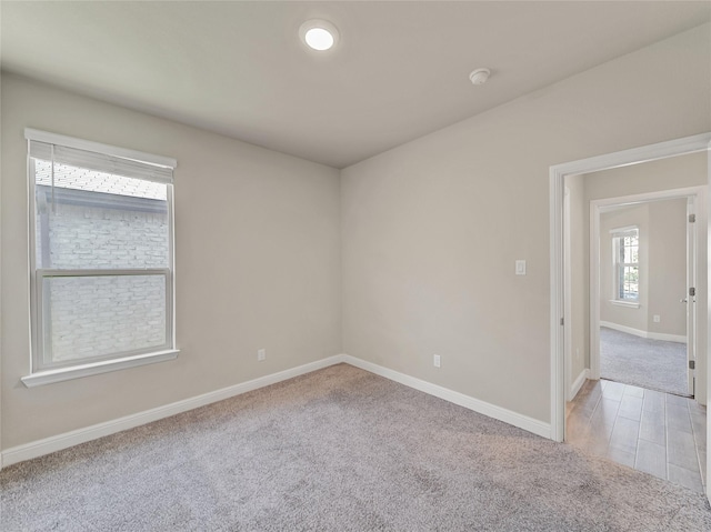 unfurnished room featuring light colored carpet