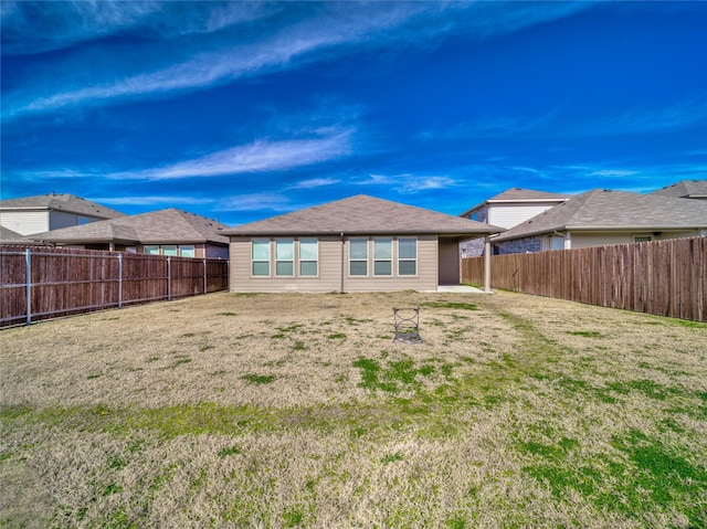 rear view of house with a yard