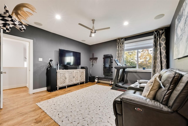 living room with ceiling fan and light wood-type flooring