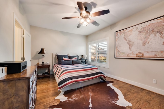 bedroom featuring hardwood / wood-style flooring and ceiling fan