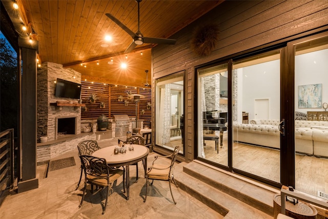 view of patio / terrace with ceiling fan, a grill, area for grilling, and a fireplace