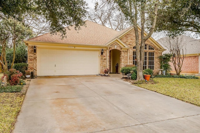 view of front of house with a front yard and a garage