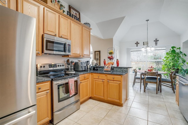 kitchen with kitchen peninsula, vaulted ceiling, appliances with stainless steel finishes, decorative light fixtures, and light tile patterned floors