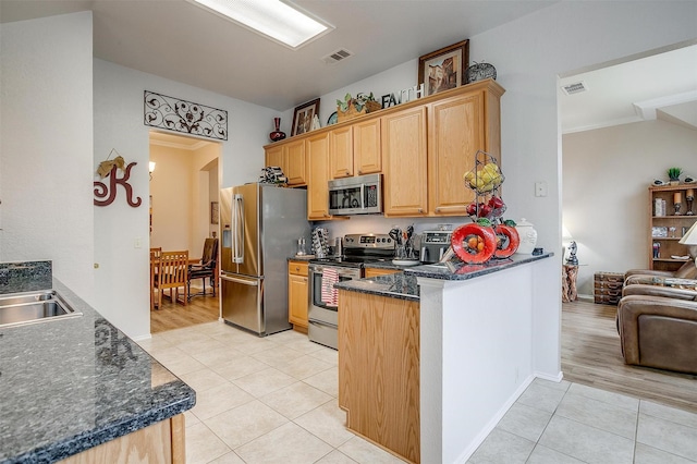 kitchen featuring kitchen peninsula, light tile patterned floors, ornamental molding, and stainless steel appliances