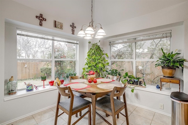 dining area with a healthy amount of sunlight, an inviting chandelier, and light tile patterned floors