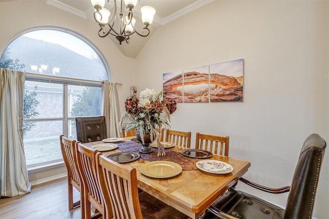 dining room with plenty of natural light, vaulted ceiling, a notable chandelier, and ornamental molding