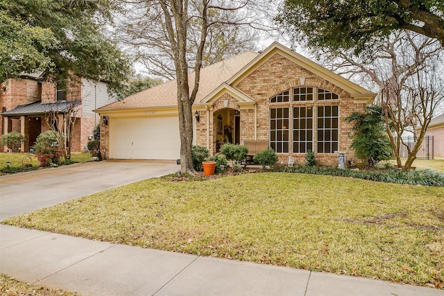 view of front of home featuring a garage and a front yard