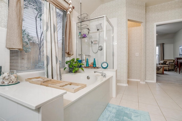 bathroom with tile patterned flooring, a wealth of natural light, and shower with separate bathtub