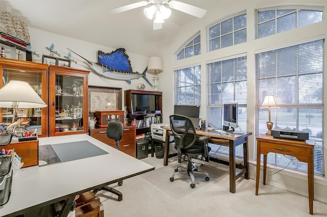 office space featuring ceiling fan, light carpet, and lofted ceiling