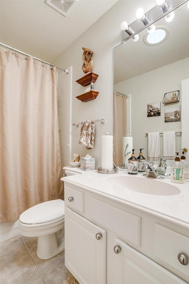 bathroom featuring walk in shower, toilet, tile patterned floors, and vanity