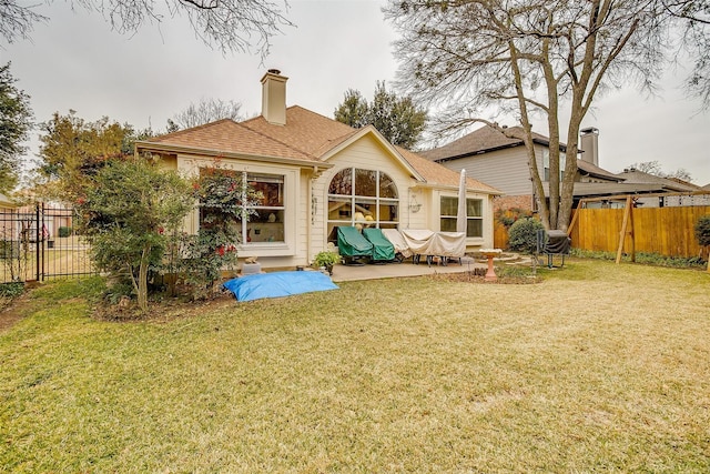 back of property featuring a yard and a patio