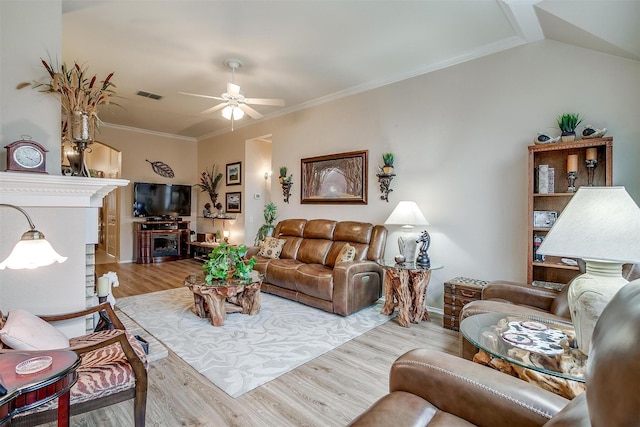 living room with ceiling fan, vaulted ceiling, crown molding, and light hardwood / wood-style floors