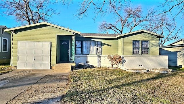 view of front of property with a garage and a front lawn