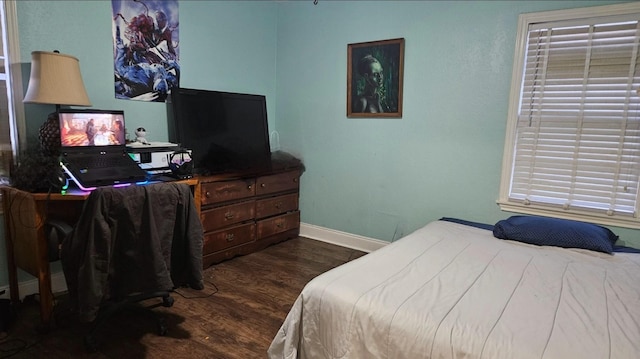 bedroom with dark wood-type flooring