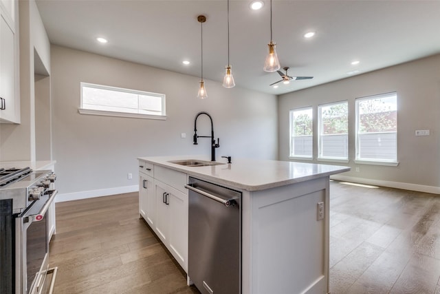 7836 Minglewood Ln, Dallas, TX 75231 - kitchen featuring appliances with stainless steel finishes, a sink, light wood-style flooring, recessed lighting, and white cabinetry