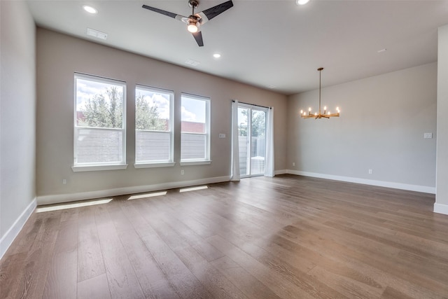 7836 Minglewood Ln, Dallas, TX 75231 - unfurnished room with a chandelier, ceiling fan, wood finished floors, baseboards, and recessed lighting