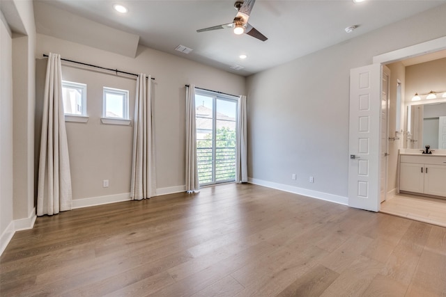 7836 Minglewood Ln, Dallas, TX 75231 - unfurnished bedroom with recessed lighting, multiple windows, light wood-style floors, and baseboards