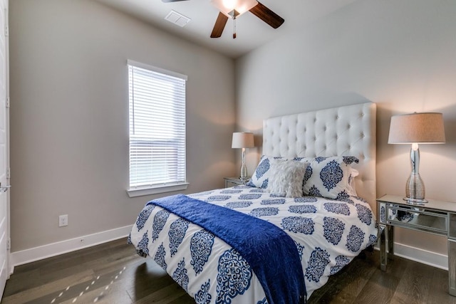 bedroom with ceiling fan, dark hardwood / wood-style flooring, and multiple windows