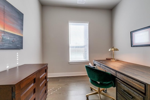 office space with wood-type flooring