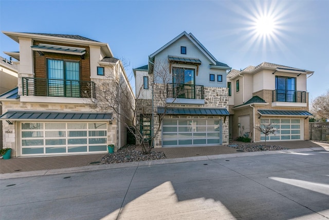 7836 Minglewood Ln, Dallas, TX 75231 - contemporary home featuring a balcony, a garage, and a standing seam roof