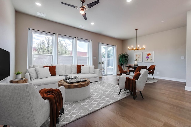 7836 Minglewood Ln, Dallas, TX 75231 - living room featuring a chandelier, light wood-style flooring, a ceiling fan, baseboards, and recessed lighting