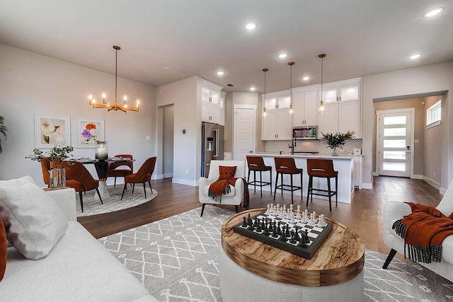 7836 Minglewood Ln, Dallas, TX 75231 - living area with dark wood-style flooring, a chandelier, baseboards, and recessed lighting