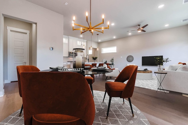 7836 Minglewood Ln, Dallas, TX 75231 - living room featuring a chandelier, dark wood finished floors, ceiling fan, and recessed lighting