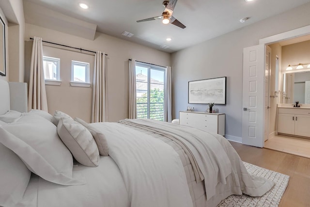 7836 Minglewood Ln, Dallas, TX 75231 - bedroom with recessed lighting, light wood-style flooring, a sink, connected bathroom, and baseboards