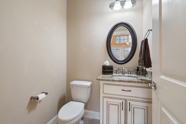 bathroom featuring toilet and vanity