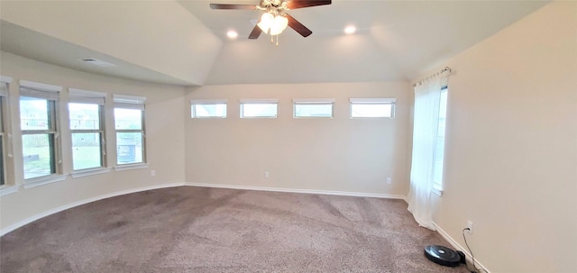 empty room featuring vaulted ceiling, ceiling fan, and carpet floors