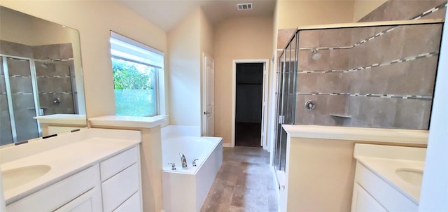 bathroom featuring vanity and shower with separate bathtub