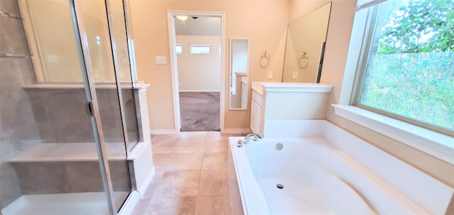 bathroom featuring vanity, a wealth of natural light, shower with separate bathtub, and tile patterned floors