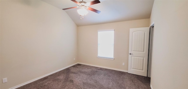 carpeted spare room with vaulted ceiling and ceiling fan