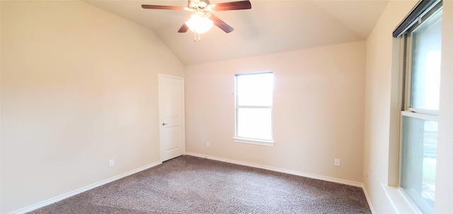 empty room with ceiling fan, carpet flooring, and lofted ceiling