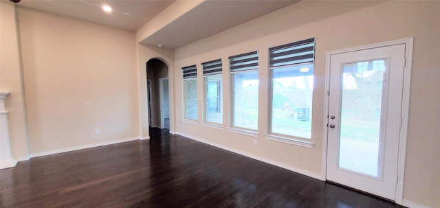 spare room with dark hardwood / wood-style floors