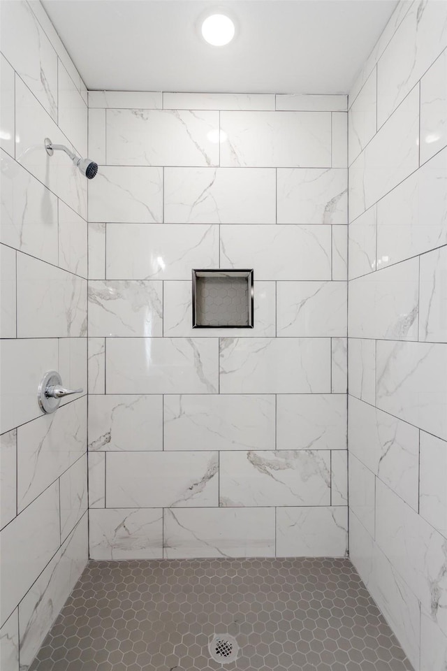 bathroom with tiled shower