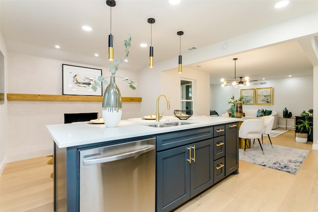 kitchen with stainless steel dishwasher, sink, decorative light fixtures, a kitchen island with sink, and light hardwood / wood-style floors