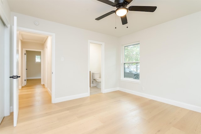 unfurnished bedroom featuring light hardwood / wood-style floors, ensuite bath, and ceiling fan