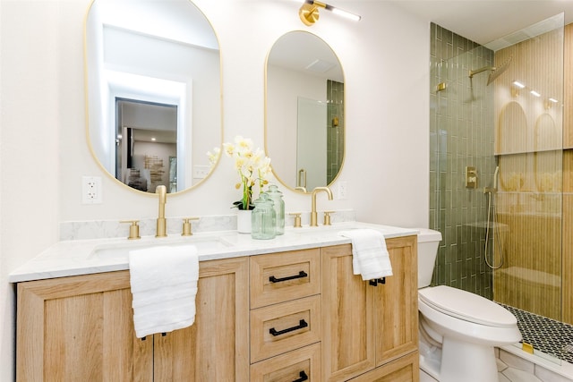 bathroom with a shower with door, toilet, and vanity