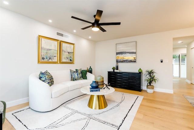 living room featuring hardwood / wood-style flooring and ceiling fan