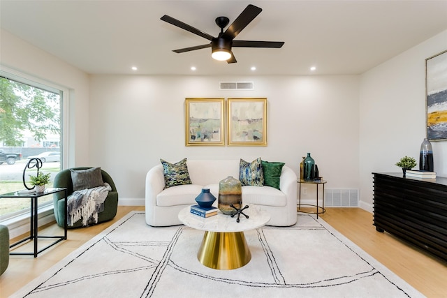 sitting room featuring hardwood / wood-style floors and ceiling fan