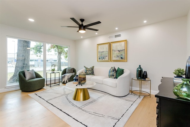 living room with ceiling fan and hardwood / wood-style floors