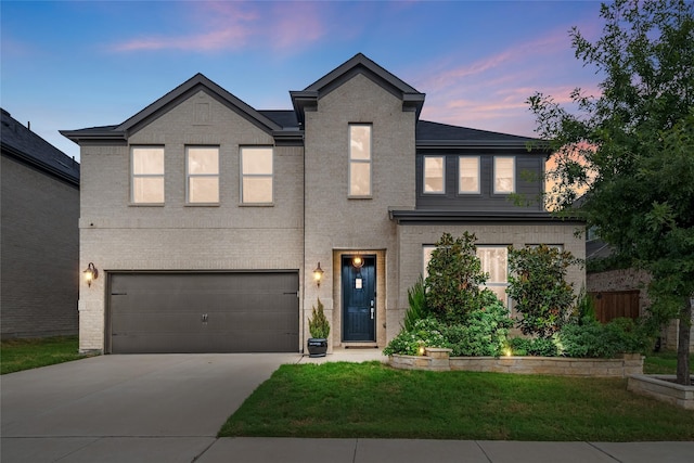 view of front of property with a lawn and a garage