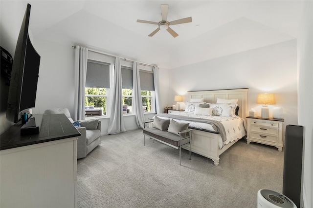 bedroom featuring light carpet, a raised ceiling, and ceiling fan